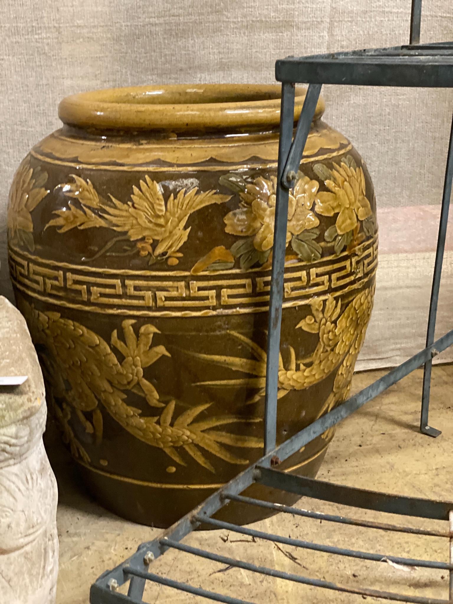 A wrought iron three tier plant stand, height 75cm and a tin glazed vase